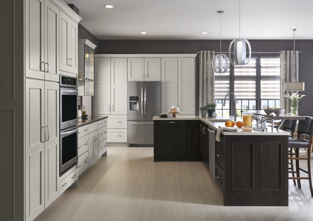 Modern kitchen remodeling project with white shaker cabinets, dark wood islands, pendant lighting, and open-concept layout by Merrell Building in Maryland