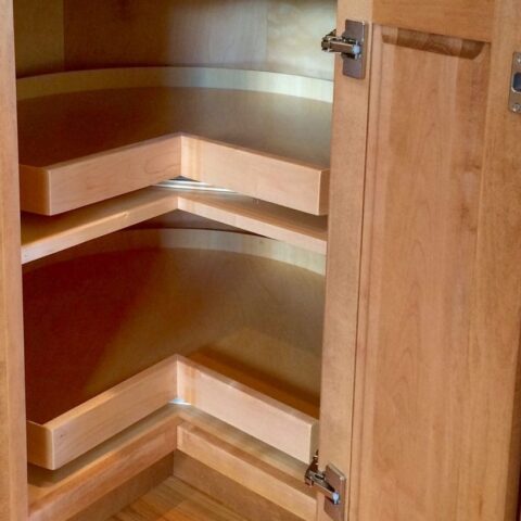 Open wood base corner cabinet featuring a Super Susan with two rotating wood trays, part of a functional and stylish kitchen design.