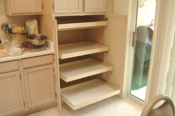 A kitchen with cabinets and shelves in it
