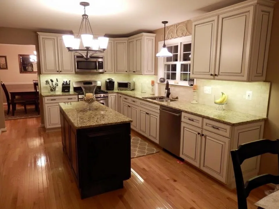 Westminster Kitchen Remodel A kitchen with white cabinets and black island.