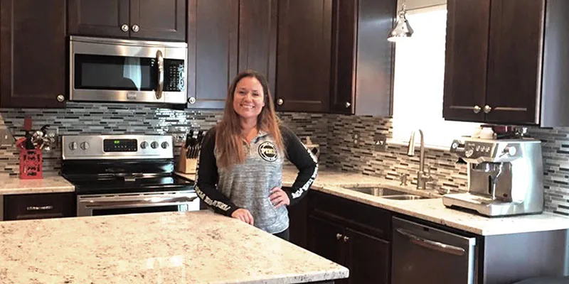 Renovated Modern Kitchen with dark wood cabinets, sleek stainless steel appliances, and stylish granite countertops.