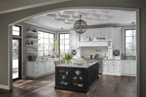 Transitional kitchen with white cabinetry, black island, open shelving, and large windows providing natural light.