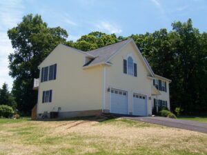 Side view of the house with expanded garage and master bedroom addition