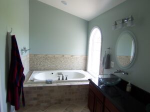 Master bathroom with built-in bathtub and arched window