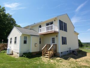 Exterior view of house showing the master bedroom suite with private balcony