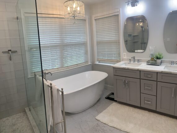 A bathroom with a tub, sink and shower.