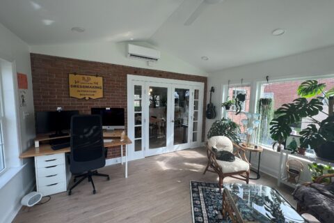 Home addition used as a bright home office and sitting area connected to main house with French doors