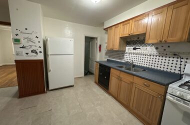 Dimly lit kitchen with single ceiling light and shadowed countertops in Westminster MD