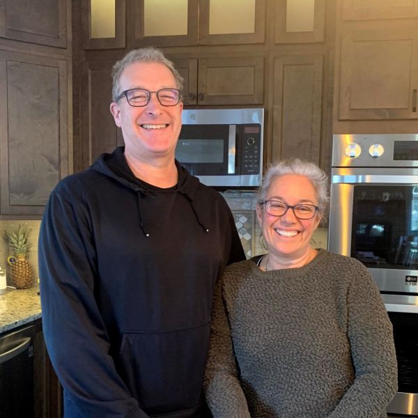 Butt clients smiling together in their remodeled kitchen.