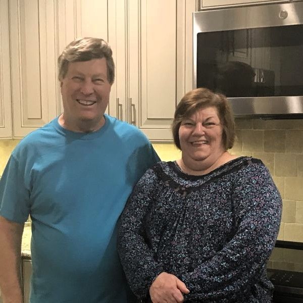Egge clients smiling together in their kitchen after a completed home project.
