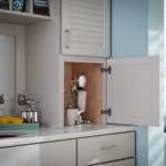 Custom bathroom cabinet with hidden storage beside a white vanity in a remodeled Columbia, MD bathroom